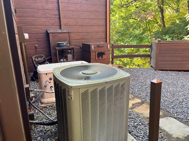 details featuring wood walls and central AC unit