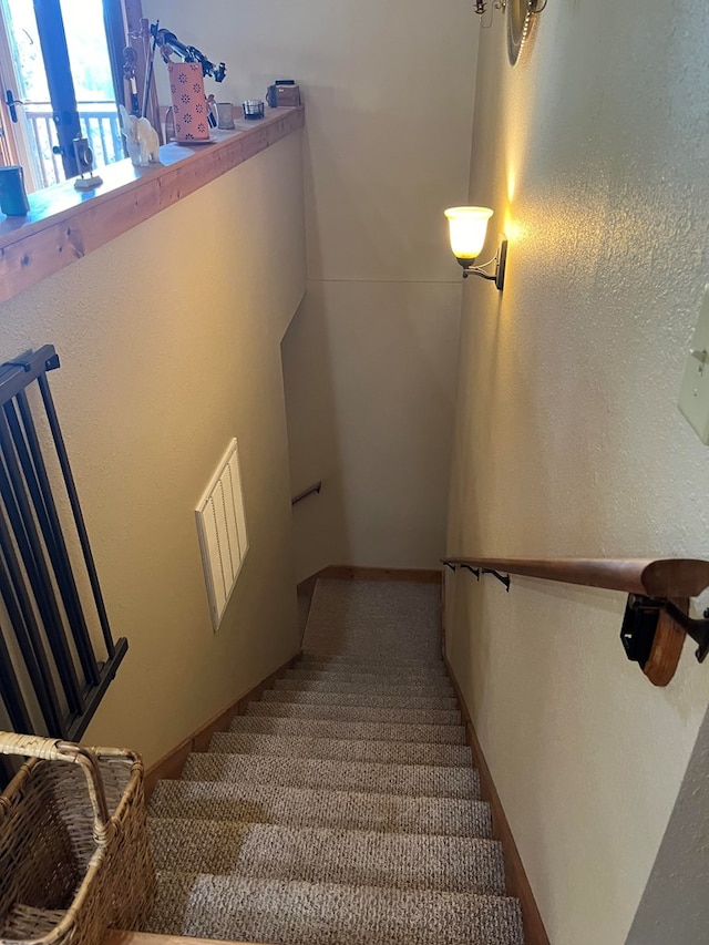 staircase with carpet floors