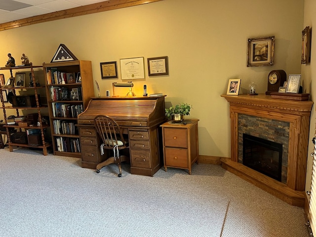 office space featuring light colored carpet and a fireplace