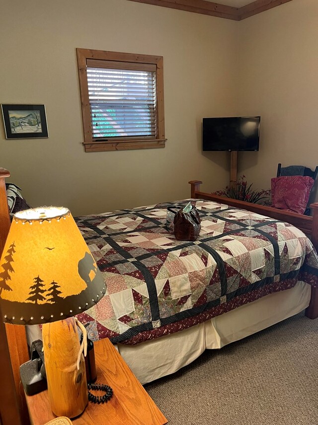 bedroom featuring carpet and crown molding