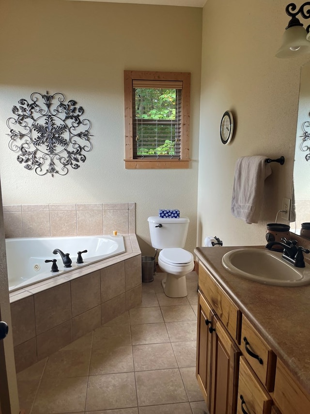 bathroom featuring vanity, tiled bath, tile patterned flooring, and toilet