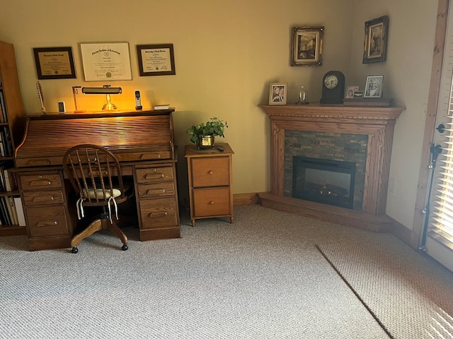 carpeted home office with a fireplace