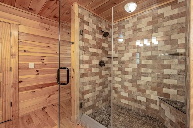 full bath with wood ceiling, a shower stall, and wood finished floors