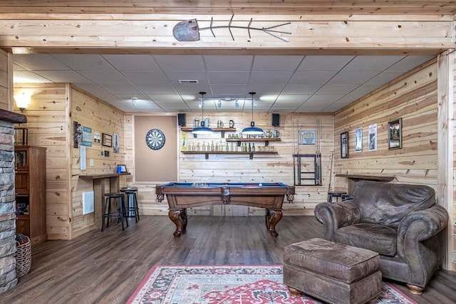 game room with pool table, visible vents, wood walls, wood finished floors, and a drop ceiling