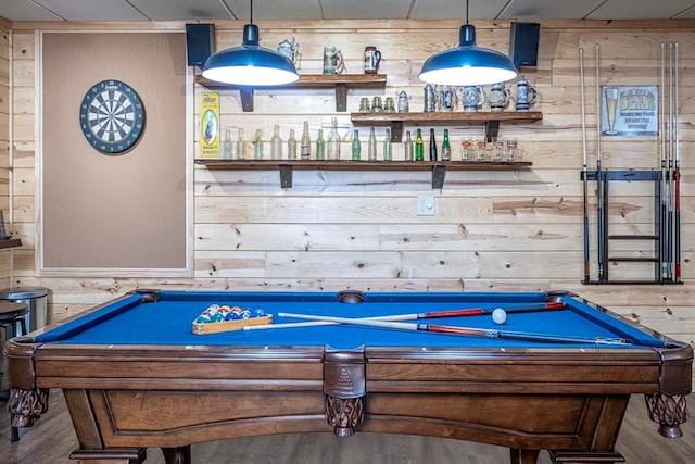 game room featuring wood finished floors, a bar, billiards, and wooden walls