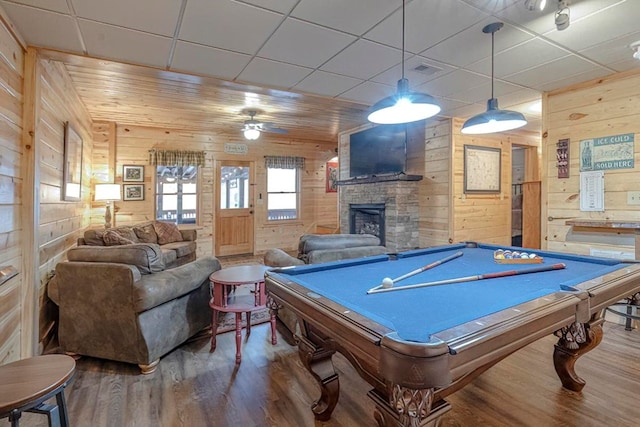 playroom featuring a fireplace, a paneled ceiling, pool table, wooden walls, and wood finished floors