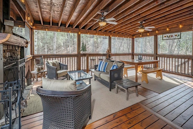 wooden terrace featuring ceiling fan and an outdoor living space