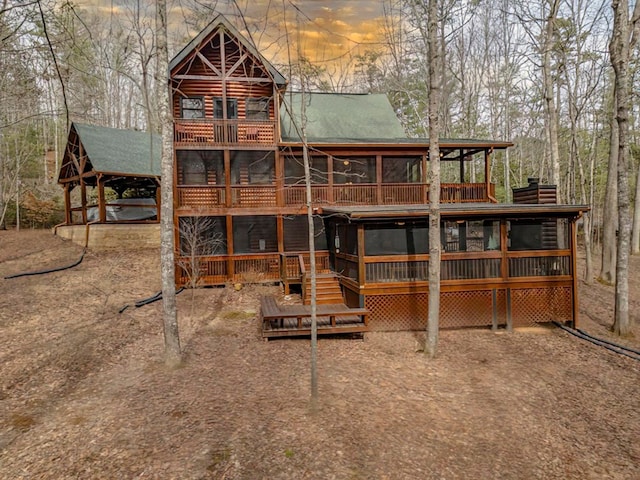 back of property featuring a chimney and a wooden deck