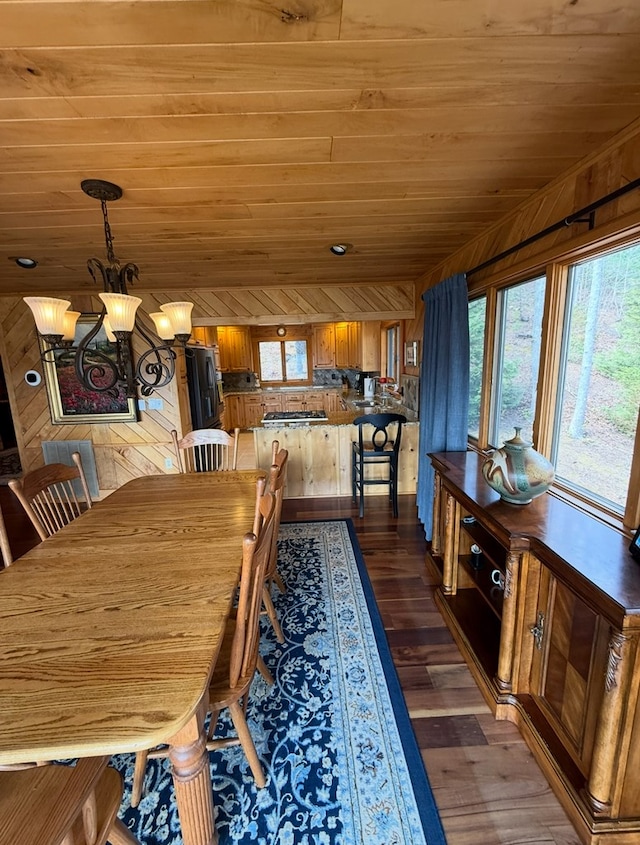 369 Deals Gap Rd, Robbinsville, NC 28771 - dining room featuring a chandelier, wooden ceiling, wood walls, and dark wood-style floors