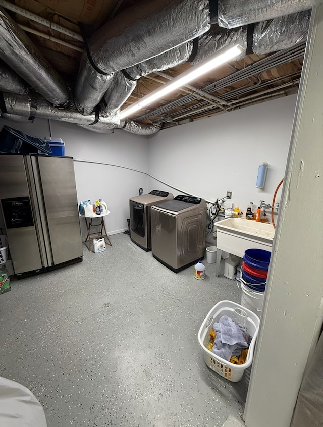 369 Deals Gap Rd, Robbinsville, NC 28771 - finished basement featuring washing machine and clothes dryer, a sink, and stainless steel fridge
