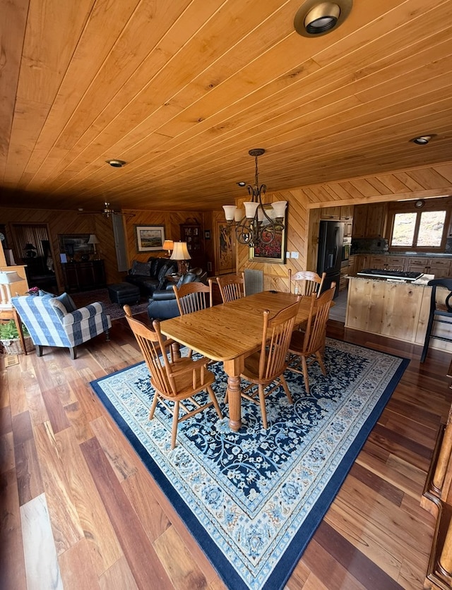 369 Deals Gap Rd, Robbinsville, NC 28771 - dining space featuring an inviting chandelier, wooden walls, wooden ceiling, and wood finished floors
