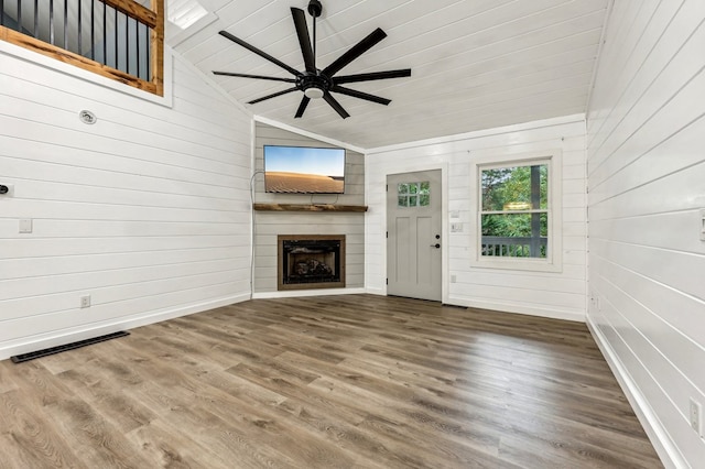 unfurnished living room with lofted ceiling, ceiling fan, hardwood / wood-style floors, and a fireplace