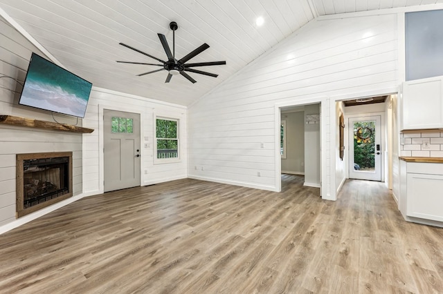 unfurnished living room featuring light hardwood / wood-style flooring, high vaulted ceiling, a large fireplace, ceiling fan, and wooden ceiling