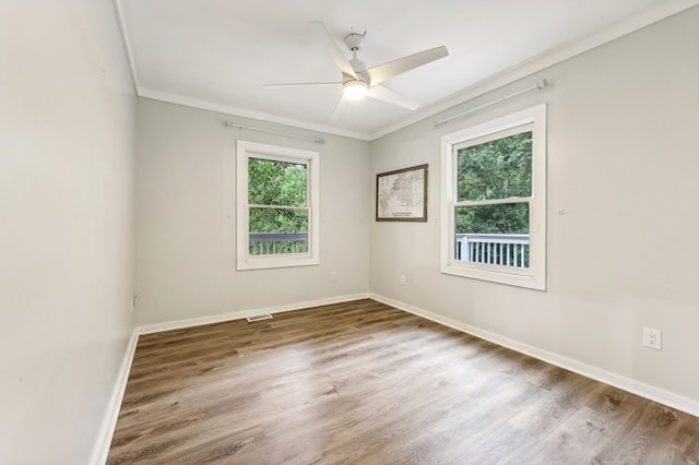 empty room with wood-type flooring, ceiling fan, and crown molding