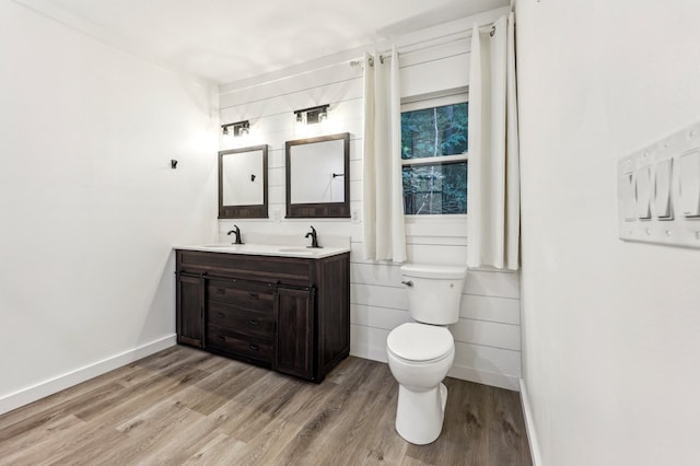 bathroom featuring vanity, toilet, and hardwood / wood-style flooring