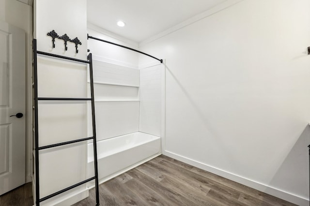 bathroom featuring wood-type flooring and shower / washtub combination