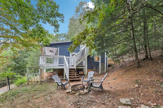 back of property featuring a deck and an outdoor fire pit