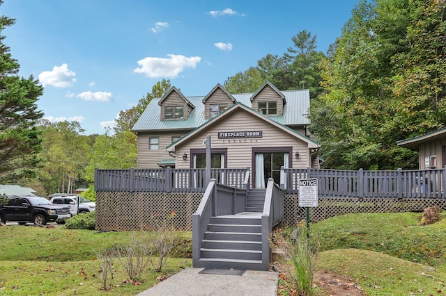 view of front of home featuring a front yard and a deck