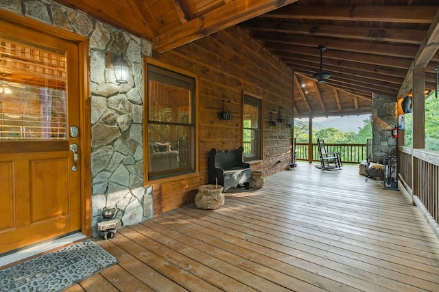 wooden terrace with ceiling fan and a porch