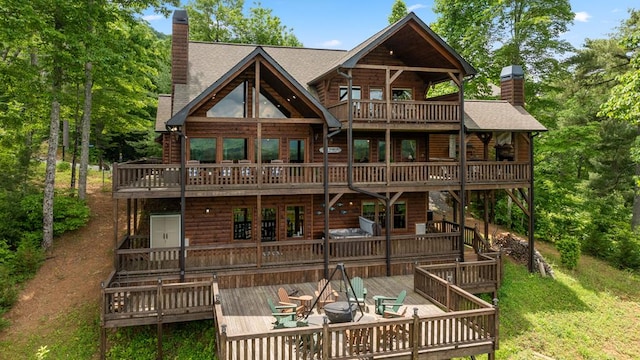 9 Quail Holw, Blue Ridge, GA 30513 - rear view of house featuring a chimney, a deck, a shingled roof, and a balcony