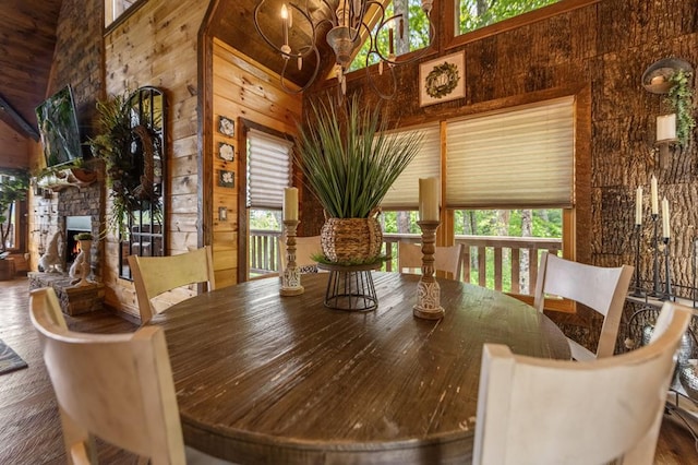 9 Quail Holw, Blue Ridge, GA 30513 - dining room featuring a towering ceiling, plenty of natural light, wooden walls, a chandelier, and wood finished floors