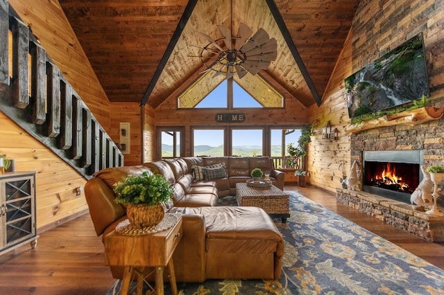 9 Quail Holw, Blue Ridge, GA 30513 - living area with wooden ceiling, hardwood / wood-style flooring, a stone fireplace, wooden walls, and a ceiling fan