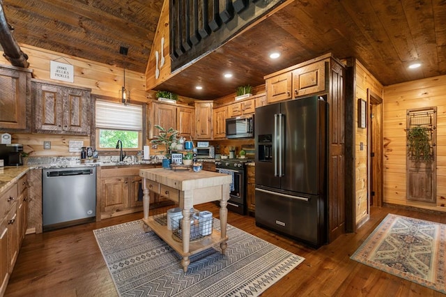 9 Quail Holw, Blue Ridge, GA 30513 - kitchen with stainless steel appliances, wood ceiling, dark wood-style flooring, wood walls, and light stone counters