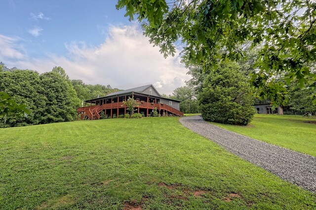 view of front facade with a deck and a front yard