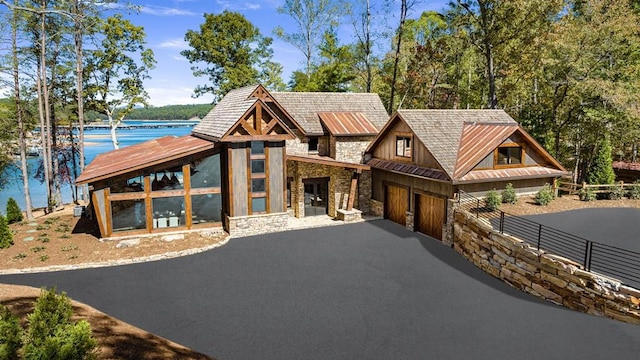 view of front of house with a garage and a water view