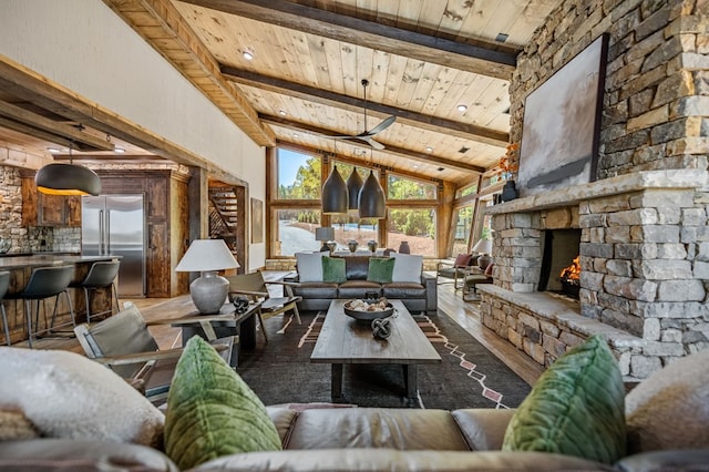 living room featuring lofted ceiling with beams, a fireplace, dark hardwood / wood-style floors, and wooden ceiling