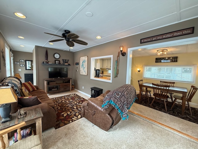 carpeted living area with a ceiling fan, baseboards, and recessed lighting
