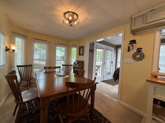 carpeted dining area featuring baseboards