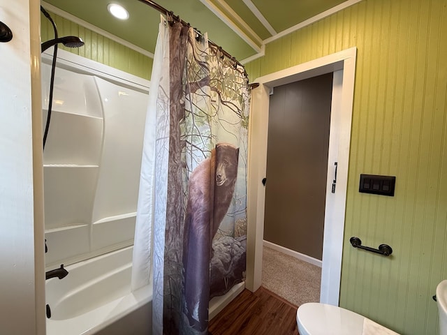 bathroom featuring shower / bath combo with shower curtain, toilet, ornamental molding, and wood finished floors