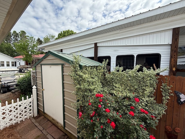 view of shed featuring fence