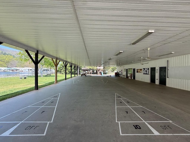 view of home's community featuring shuffleboard and a yard