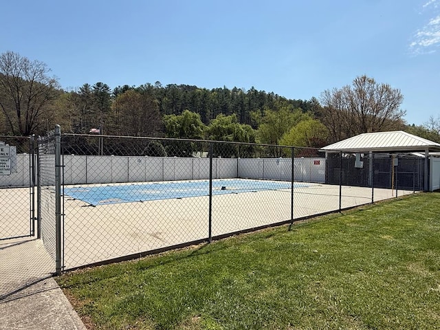pool with fence and a yard