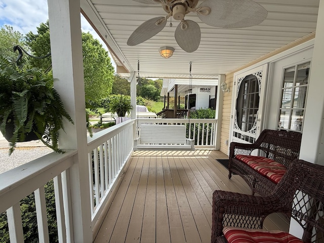 wooden terrace with ceiling fan and a porch