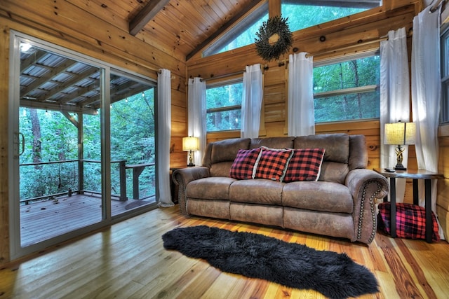 living room with hardwood / wood-style floors, wooden ceiling, vaulted ceiling with beams, and wood walls