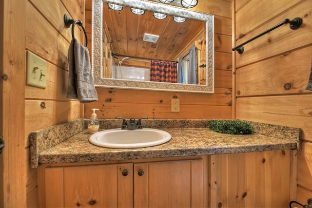 full bathroom with wood walls, wooden ceiling, vanity, and a shower with shower curtain