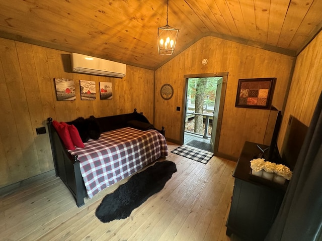 bedroom with lofted ceiling, wood walls, wooden ceiling, light wood-type flooring, and a wall unit AC