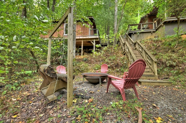 view of yard with stairway and an outdoor fire pit