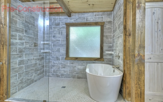 bathroom featuring tiled shower, tile walls, and wood ceiling