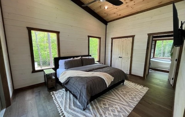 bedroom featuring multiple windows, ceiling fan, dark hardwood / wood-style flooring, and vaulted ceiling