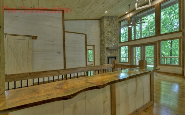 interior space featuring a stone fireplace and ceiling fan