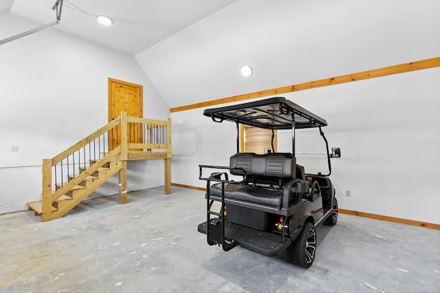 workout area featuring concrete flooring and vaulted ceiling