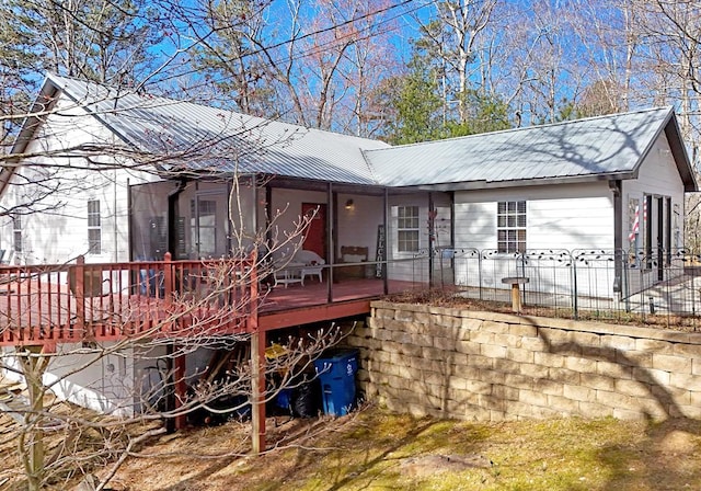 view of front of home featuring metal roof and a wooden deck