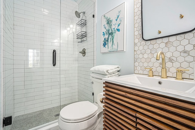 bathroom featuring vanity, an enclosed shower, and toilet