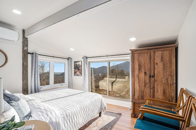 bedroom featuring multiple windows, access to exterior, light hardwood / wood-style floors, and a wall mounted AC