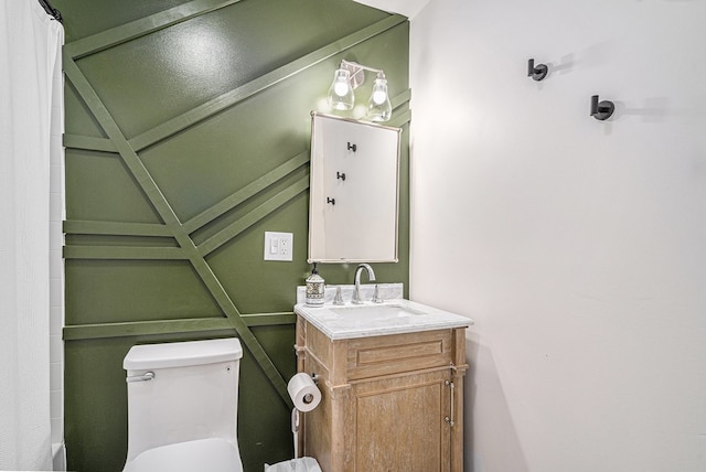 full bathroom with vanity, shower / tub combo with curtain, and toilet