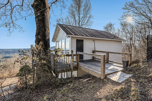 back of house featuring central AC unit and a wooden deck